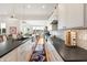 Galley kitchen features modern cabinets, dark countertops, stainless steel appliances, and an open layout with natural light at 201 St Andrews Ave, Edinburgh, IN 46124