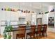 Well-lit modern kitchen features white cabinets, stainless appliances, subway tile backsplash, and a large island with seating at 201 St Andrews Ave, Edinburgh, IN 46124