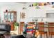 Modern kitchen with white cabinets, stainless steel appliances, and a view into the living room seating area at 201 St Andrews Ave, Edinburgh, IN 46124