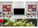 Living room fireplace with white subway tile surround, built-in cabinets with glass decorations, and modern artwork at 201 St Andrews Ave, Edinburgh, IN 46124