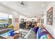 Open-concept living area with view into kitchen; features hardwood floors, neutral furnishings, and plenty of natural light at 201 St Andrews Ave, Edinburgh, IN 46124
