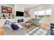 Bright living room featuring a fireplace with white subway tile, built-in cabinets, and a large window with a view at 201 St Andrews Ave, Edinburgh, IN 46124