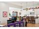 Bright living room showcasing an open floor plan that leads to a kitchen and dining area at 201 St Andrews Ave, Edinburgh, IN 46124