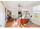 Bright craft room with wood floors, a sewing station, shelving, and a quilt hanging on the wall at 201 St Andrews Ave, Edinburgh, IN 46124