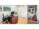 Spacious office with hardwood floors, a desk, an accent chair, and double doors leading to another room at 201 St Andrews Ave, Edinburgh, IN 46124