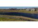 Scenic view of a serene pond, lush green surroundings, and a home in a tranquil neighborhood at 201 St Andrews Ave, Edinburgh, IN 46124