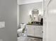 Beautiful powder room with modern vanity, stylish lighting, and tile floor at 201 St Andrews Ave, Edinburgh, IN 46124