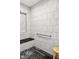 Elegant tiled shower with a built-in bench, convenient grab bars, and patterned tile floor at 201 St Andrews Ave, Edinburgh, IN 46124