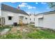 Backyard showcasing a white house with a detached garage, offering a cozy outdoor space at 2015 S Hackley St, Muncie, IN 47302