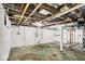 Unfinished basement, exposed beams, and utility connections offering potential for customization at 2015 S Hackley St, Muncie, IN 47302