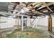 Unfinished basement with exposed beams, and utility connections offers potential for future customization at 2015 S Hackley St, Muncie, IN 47302
