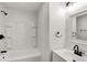 This bathroom features black fixtures, a shower over the tub, and a sink with modern white vanity at 2015 S Hackley St, Muncie, IN 47302