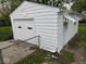 View of detached one car garage with white siding and alley access at 2015 S Hackley St, Muncie, IN 47302
