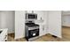 Updated kitchen with stainless steel oven, microwave, and white cabinets at 2015 S Hackley St, Muncie, IN 47302