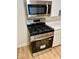 Stainless steel gas range and microwave appliances with modern white cabinets create a sleek kitchen design at 2015 S Hackley St, Muncie, IN 47302