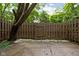 A fenced-in yard has tree coverage and a pebble surround at 2263 Rome Dr, Indianapolis, IN 46228