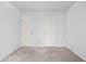 This carpeted bedroom has two closets with white doors at 2263 Rome Dr, Indianapolis, IN 46228
