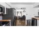 View of the kitchen into the dining room featuring a modern aesthetic and sleek appliances at 2263 Rome Dr, Indianapolis, IN 46228