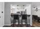 Open kitchen area with white cabinets and bar seating, ideal for casual dining at 2263 Rome Dr, Indianapolis, IN 46228