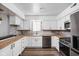 Modern kitchen with white cabinets, brick backsplash, stainless steel appliances, and wood countertops at 2263 Rome Dr, Indianapolis, IN 46228