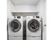 White front-loading Samsung washer and dryer in a small laundry room at 2263 Rome Dr, Indianapolis, IN 46228