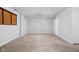 Neutral-toned living room includes carpet, a ceiling fan, and a door at 2263 Rome Dr, Indianapolis, IN 46228