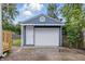 Garage with a white door that offers ample space for parking and storage with a fenced yard at 2315 Spann Ave, Indianapolis, IN 46203