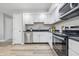 Modern kitchen featuring white cabinetry, stainless steel appliances and black countertops at 2315 Spann Ave, Indianapolis, IN 46203