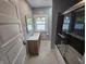 Bathroom with vanity, mirror, shower with glass door and tiled floor at 24 N Randolph St, Indianapolis, IN 46201