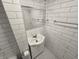 Updated bathroom features white subway tile and a black and white mosaic floor at 24 N Randolph St, Indianapolis, IN 46201