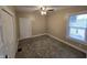 This carpeted bedroom has a ceiling fan and a door that leads to the outside at 24 N Randolph St, Indianapolis, IN 46201