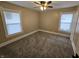 Bedroom featuring carpet, ceiling fan, and two windows that provide natural light at 24 N Randolph St, Indianapolis, IN 46201