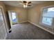 This carpeted bedroom has a ceiling fan and a door that leads to the outside at 24 N Randolph St, Indianapolis, IN 46201