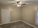 This carpeted bedroom has a ceiling fan and architectural trim on the walls at 24 N Randolph St, Indianapolis, IN 46201