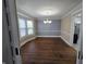 Elegant dining room with a bay window, hardwood floors, and a decorative chandelier at 24 N Randolph St, Indianapolis, IN 46201