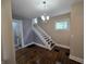 Dining room with hardwood floors, chandelier, and staircase access at 24 N Randolph St, Indianapolis, IN 46201