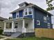 Two-story home features a white-columned front porch and blue siding at 24 N Randolph St, Indianapolis, IN 46201
