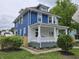 Two-story home featuring a white-columned porch and blue siding at 24 N Randolph St, Indianapolis, IN 46201