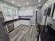 Modern kitchen features stainless steel appliances and black countertops at 24 N Randolph St, Indianapolis, IN 46201