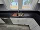 Modern kitchen sink with black countertop and white cabinets at 24 N Randolph St, Indianapolis, IN 46201