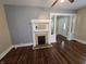 Living room features a fireplace, hardwood floors, and natural light from several windows at 24 N Randolph St, Indianapolis, IN 46201