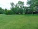 View of the spacious yard with mature trees and lush greenery providing a serene atmosphere at 2625 S 200 E, Lebanon, IN 46052