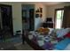Cozy bedroom with a wooden bed frame, colorful quilt, and access to a private bathroom at 2625 S 200 E, Lebanon, IN 46052