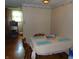 Dining area with a table set for four, wood floors, and adjacent kitchen view at 2625 S 200 E, Lebanon, IN 46052