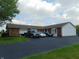 View of the exterior showing the brick and siding, driveway and multiple cars parked at 2625 S 200 E, Lebanon, IN 46052
