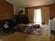 Cozy living room featuring wood paneling, a wood stove, and warm, inviting furniture at 2625 S 200 E, Lebanon, IN 46052