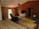 Cozy living room featuring wood paneling, a sliding door, and warm, inviting furniture at 2625 S 200 E, Lebanon, IN 46052
