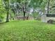Large backyard featuring a shed, mature trees, and a well-maintained lawn at 2741 Fairlawn Dr, Columbus, IN 47203