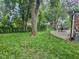 Spacious backyard with patio, dining set, and mature trees creating a serene atmosphere at 2741 Fairlawn Dr, Columbus, IN 47203