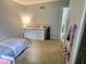 Cozy bedroom with neutral decor and large dresser for ample storage at 2741 Fairlawn Dr, Columbus, IN 47203